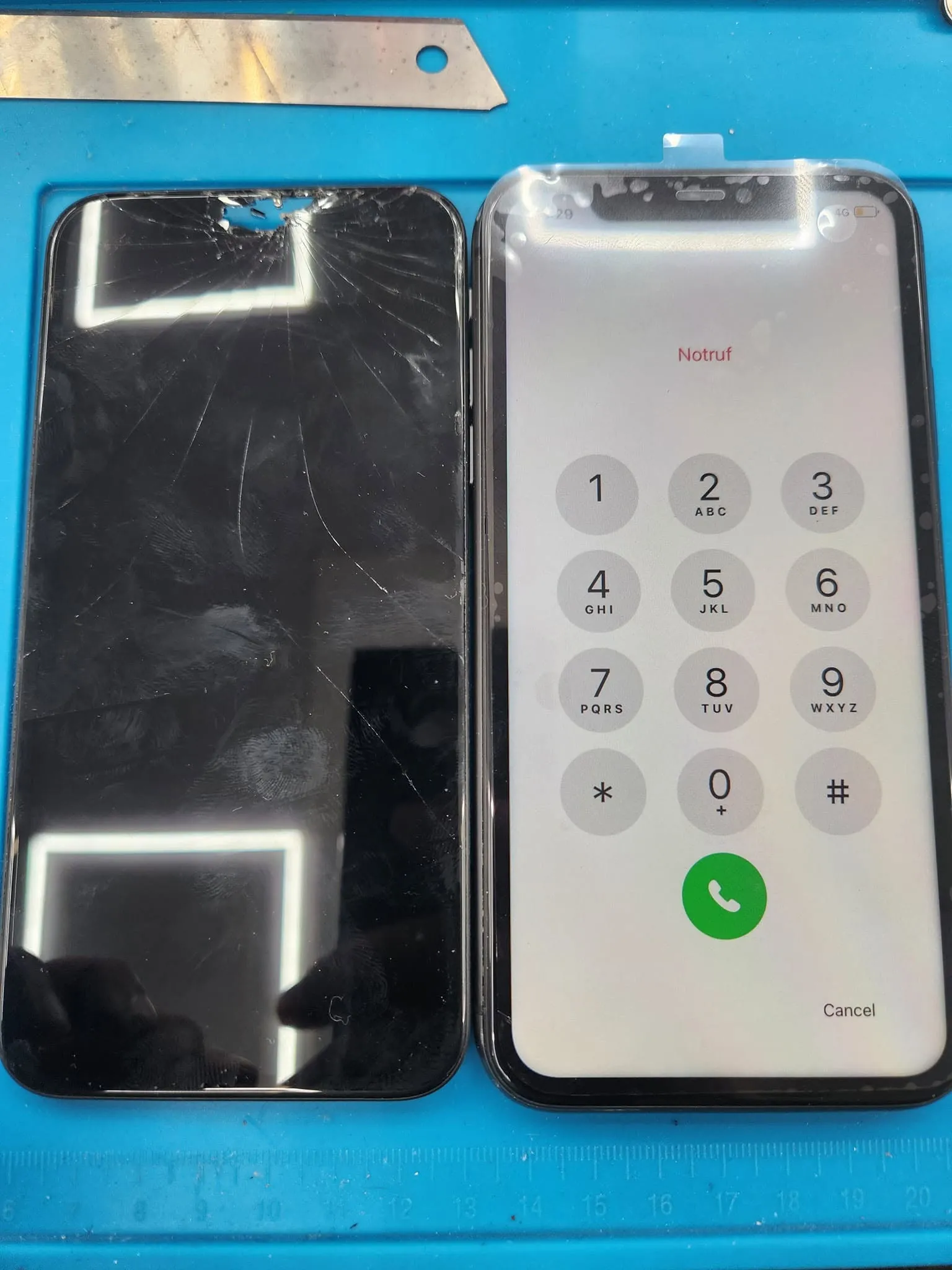 A cracked iPhone screen taken off the phone, on the repair mat beside the same phone with its new screen working.
